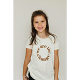White kids graphic tee in organic cotton featuring a stylish brown circular text design