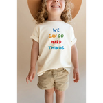Child wearing We Can Do Hard Things Kids Graphic T-Shirt with fade-resistant inks