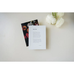 White paper card with text next to floral-patterned card, shipping featuring poetry excerpts