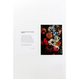 Colorful floral art print with poetry excerpts and free shipping displayed in a book