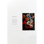 Book page with text and colorful floral art print, with free shipping featuring excerpts