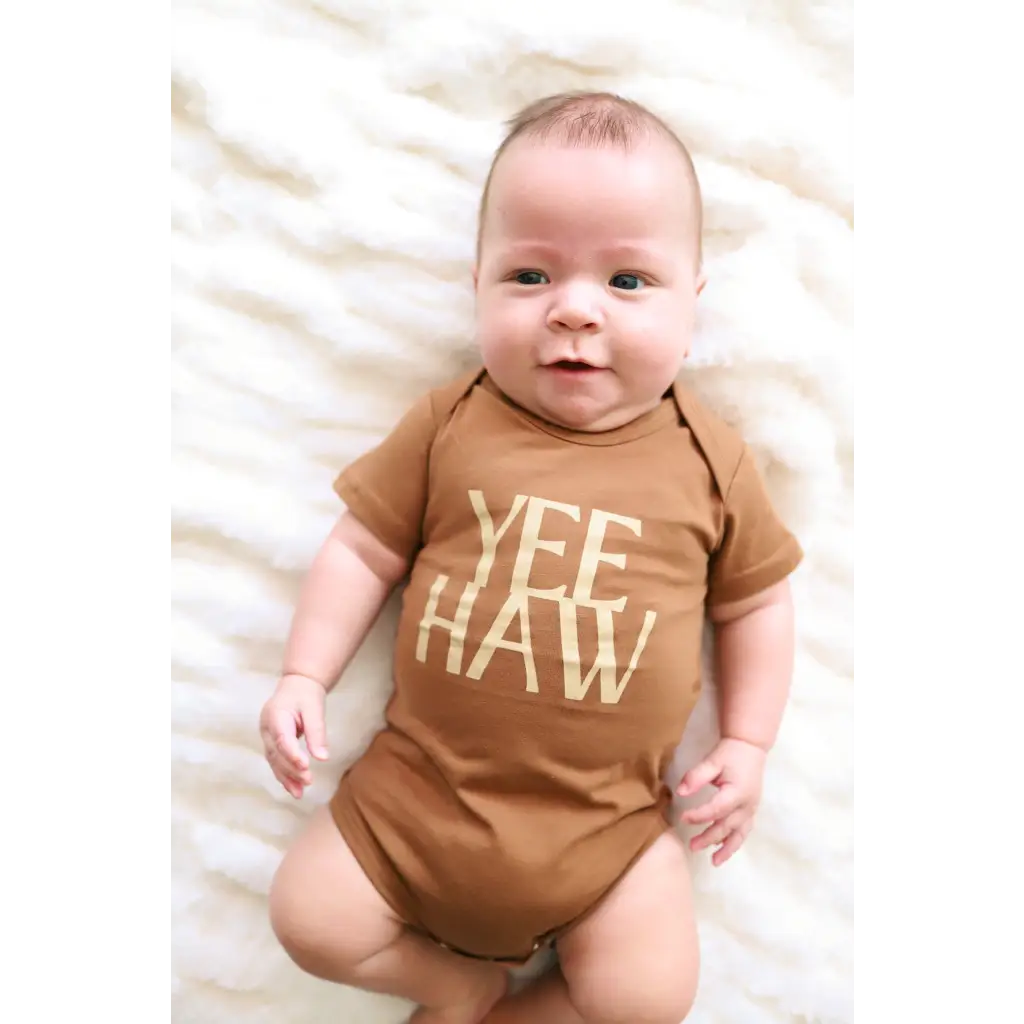Brown organic cotton baby onesie with Yee Haw text for little cowboys and cowgirls