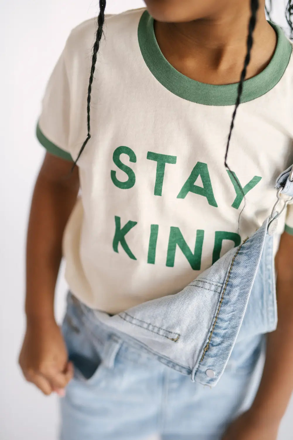 Cute white t-shirt with green STAY KIND text, perfect for toddlers with round retro sunglasses.