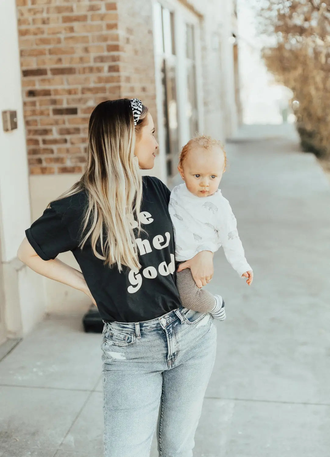 Parent and baby in casual wear showcasing original polished prints pieces.