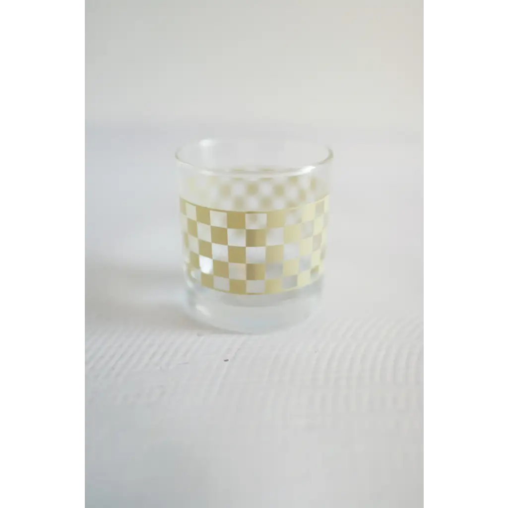 Glass tumbler with a fun white and yellow checkered pattern, perfect for cocktails