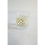 Glass tumbler with a fun white and yellow checkered pattern, perfect for cocktails