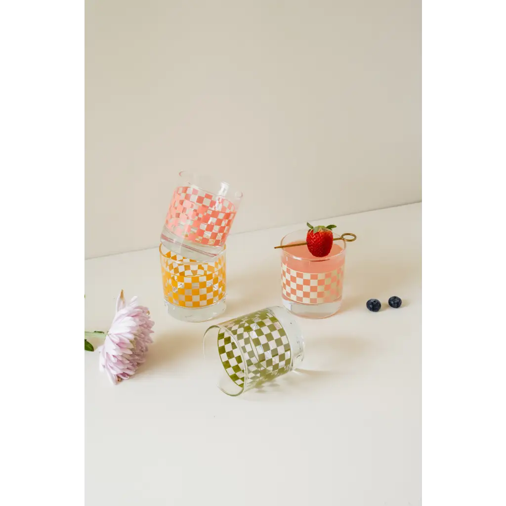 Colorful heavy-based 11oz checkered cocktail glasses stacked with fresh berries