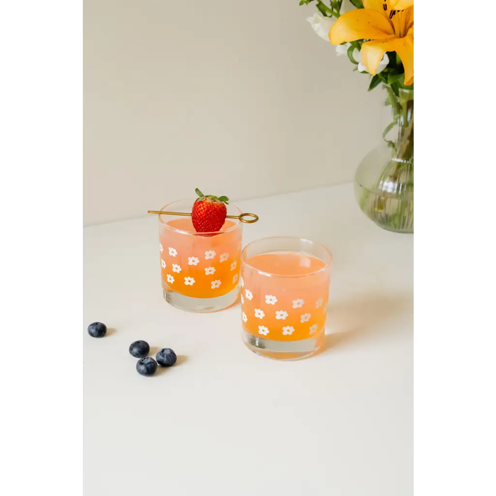 Two orange cocktails in floral glasses showcasing a heavy-based 11oz checkered design