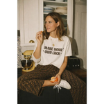 White oversized unisex tee with Make Your Own Luck graphic in cotton comfort