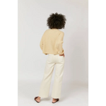 Cream-colored linen blazer with high rise wide-leg pants and black sandals
