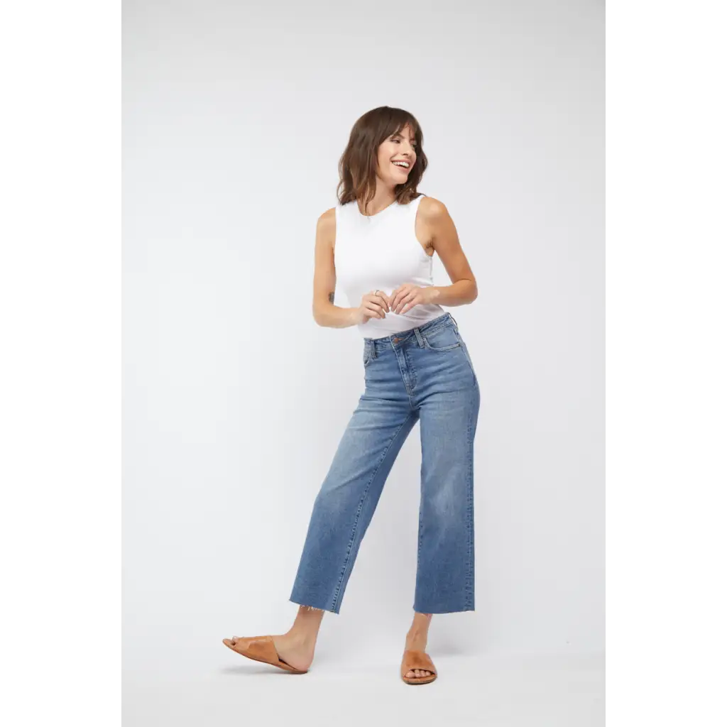 White sleeveless tank with high neckline and cropped hem over Aberdeen high rise vintage worn jeans