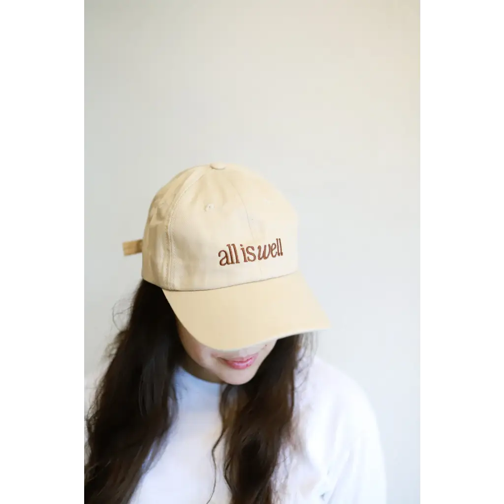 Beige embroidered baseball hat with all is well text perfect for casual vibes