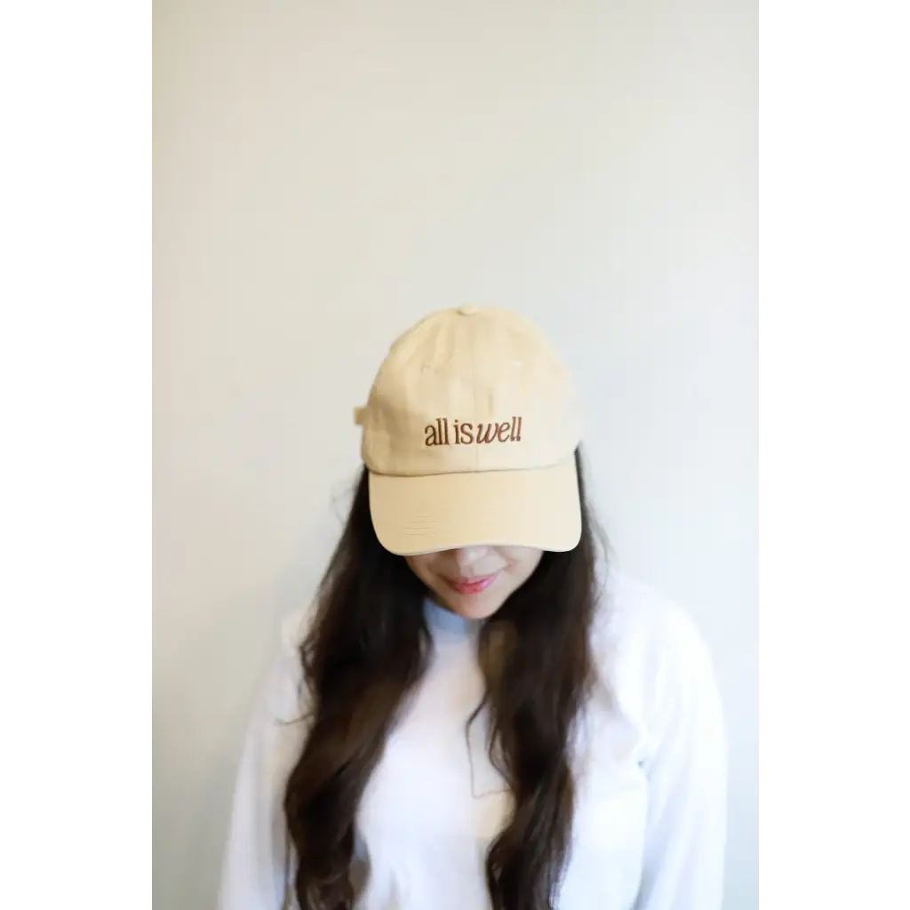 Beige embroidered baseball hat featuring All is Well message for a trendy look