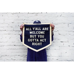 Navy blue pennant sign by Orleans artist Dr. Bob saying All Yall Are Welcome but You Gotta Act Right
