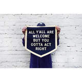 Navy blue pennant sign by Orleans artist Dr. Bob saying All Yall Are Welcome but You Gotta Act Right
