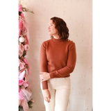 Stylish Ava Mock-Neck Sweater: brown turtleneck with ribbed cuffs, white pants for moms