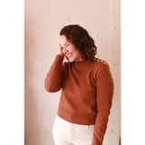 Stylish Ava Mock-Neck Sweater in rust ribbed knit with shoulder buttons