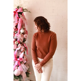 Rose gold Ava Mock-Neck Sweater with pearls and white pants, stylish womens clothes