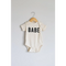 White baby onesie made of organic cotton fabric with Babe printed in bold black letters