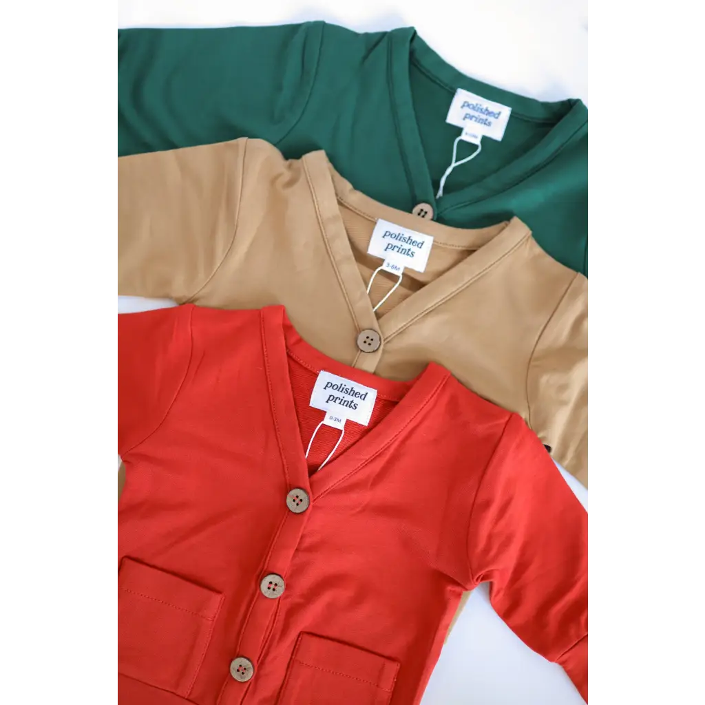 Three buttery soft baby grandpa cardigans in green, beige, and red for the holiday season