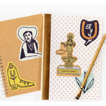 Two notebooks with western-themed stickers on a Bad Vibes Trophy Sticker from Polished Prints