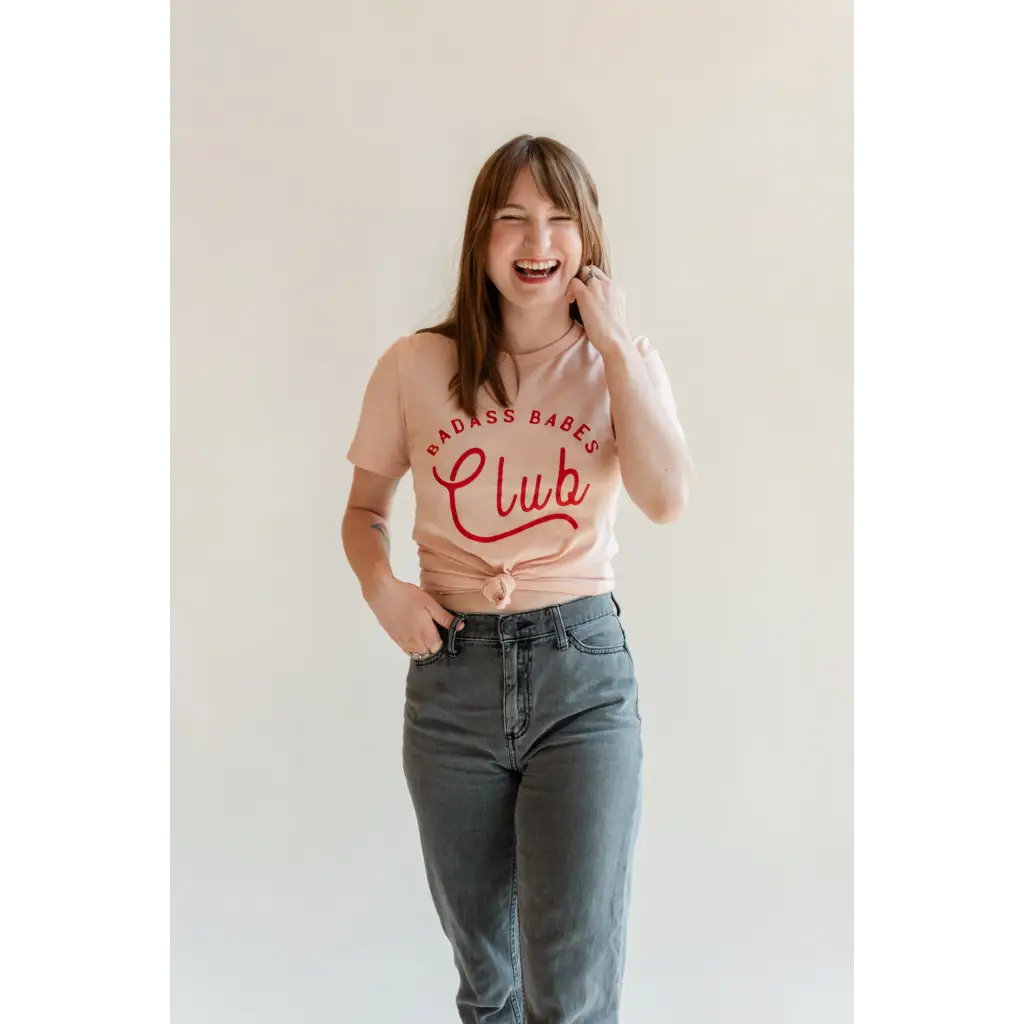 Joyful person in a pink Club crop top and gray jeans from Badass Babes Club