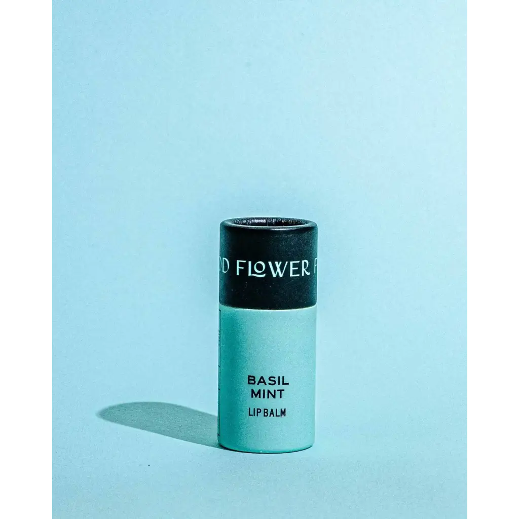 Sleek mint green Basil Mint Organic Lip Balm tube with black cap