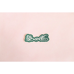 Be Nice iron-on patch with green cursive lettering and white outline for spreading kindness