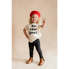 Child in a red beret rocking a Be the Good organic cotton graphic t-shirt by Polished Prints