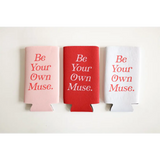 Three colorful printed seltzer koozies in pink, red, and white that say Be Your Own Muse