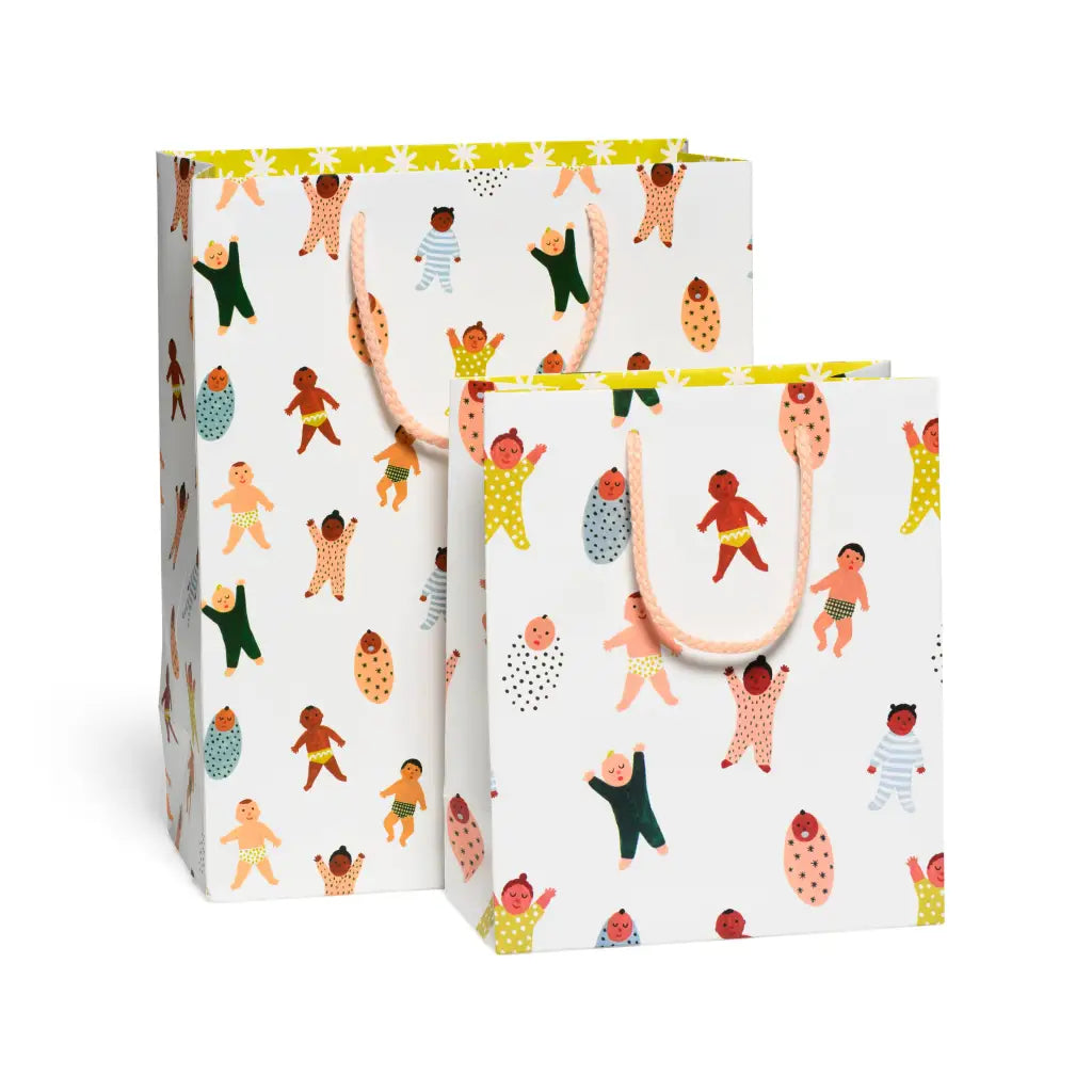 White gift bags with colorful baby designs and handles, perfect for stylish moms