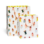 White gift bags with colorful baby designs and handles, perfect for stylish moms