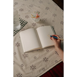 Open blank notebook with pen, perfect for stylish womens clothes or clothes for moms