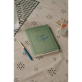 Green Begin Again journal with polished prints in stylish womens clothes for moms