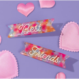 Colorful watercolor ribbons say Best Friends on cute hair clips with pink hearts