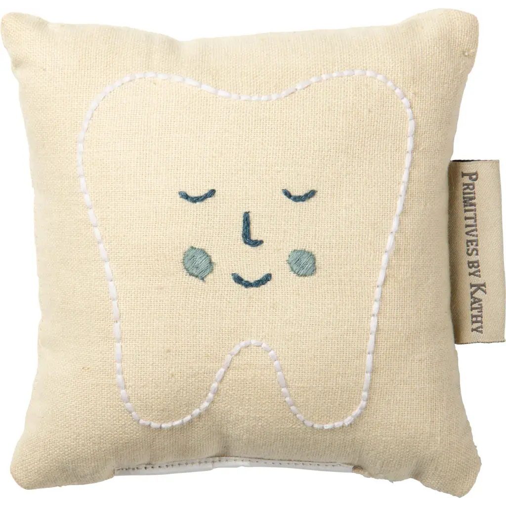Cute smiling tooth fairy pillow in soft beige with blue eyes and white stitching