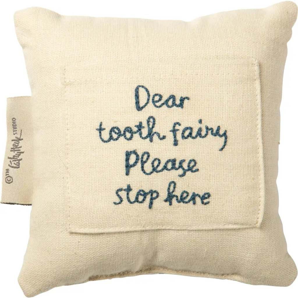Cream-colored linen tooth fairy pillow with blue embroidered pocket text
