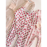 Polished white bamboo baby sleeper onesie with red strawberries