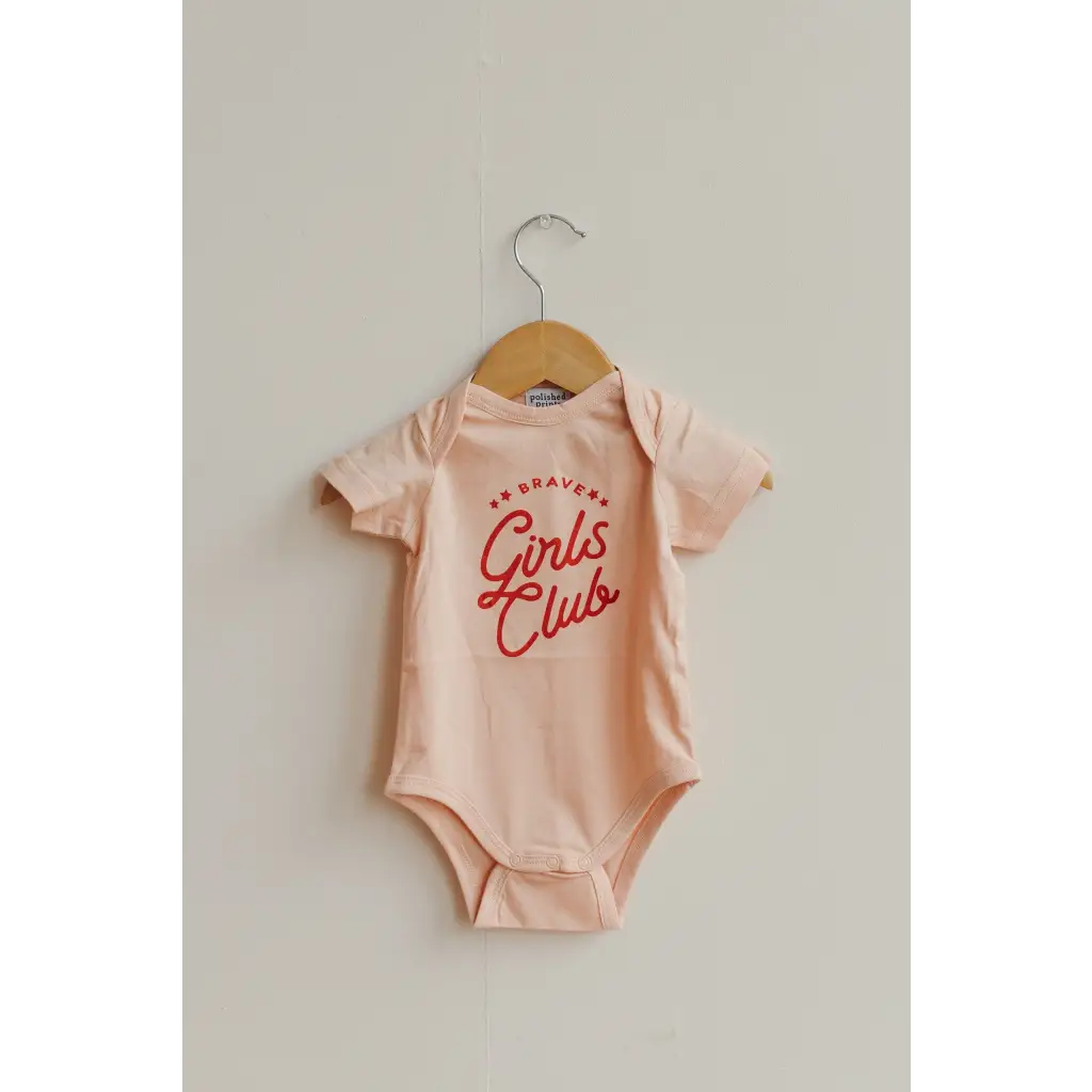 Pink baby onesie with red Girls Club text for Brave Girls Club cuties