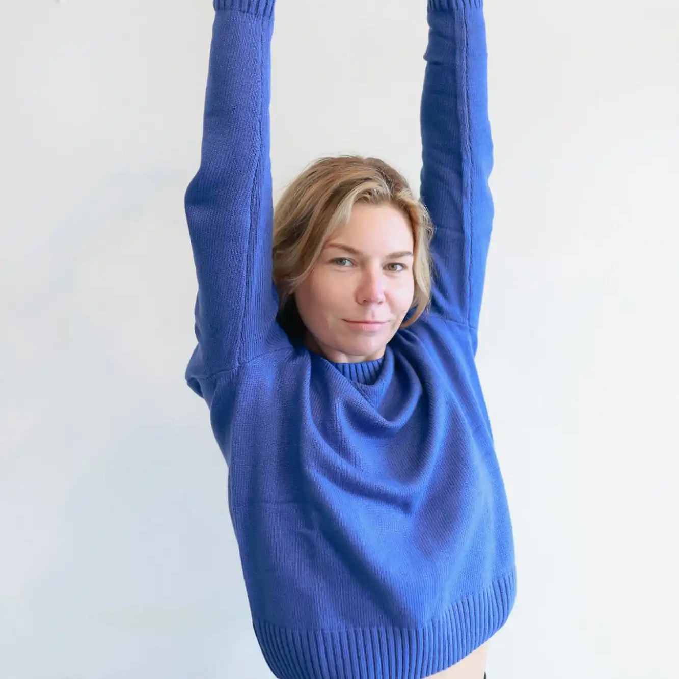 Bright blue knit sweater with ribbed cuffs and hem.