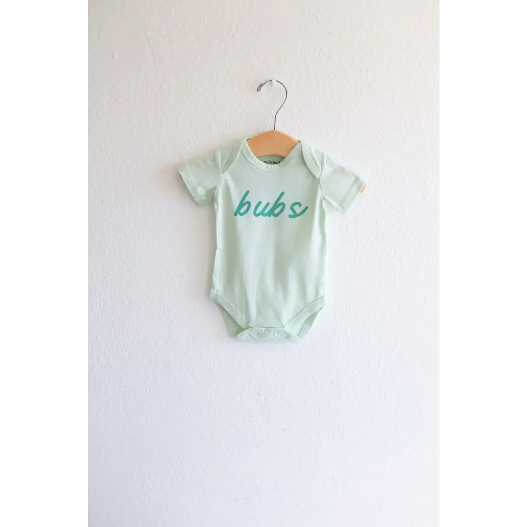 Mint green organic cotton baby onesie with bub text on a metal hanger for stylish babywear