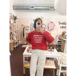 Red long-sleeved adult unisex pullover with Can someone put a woman in charge text