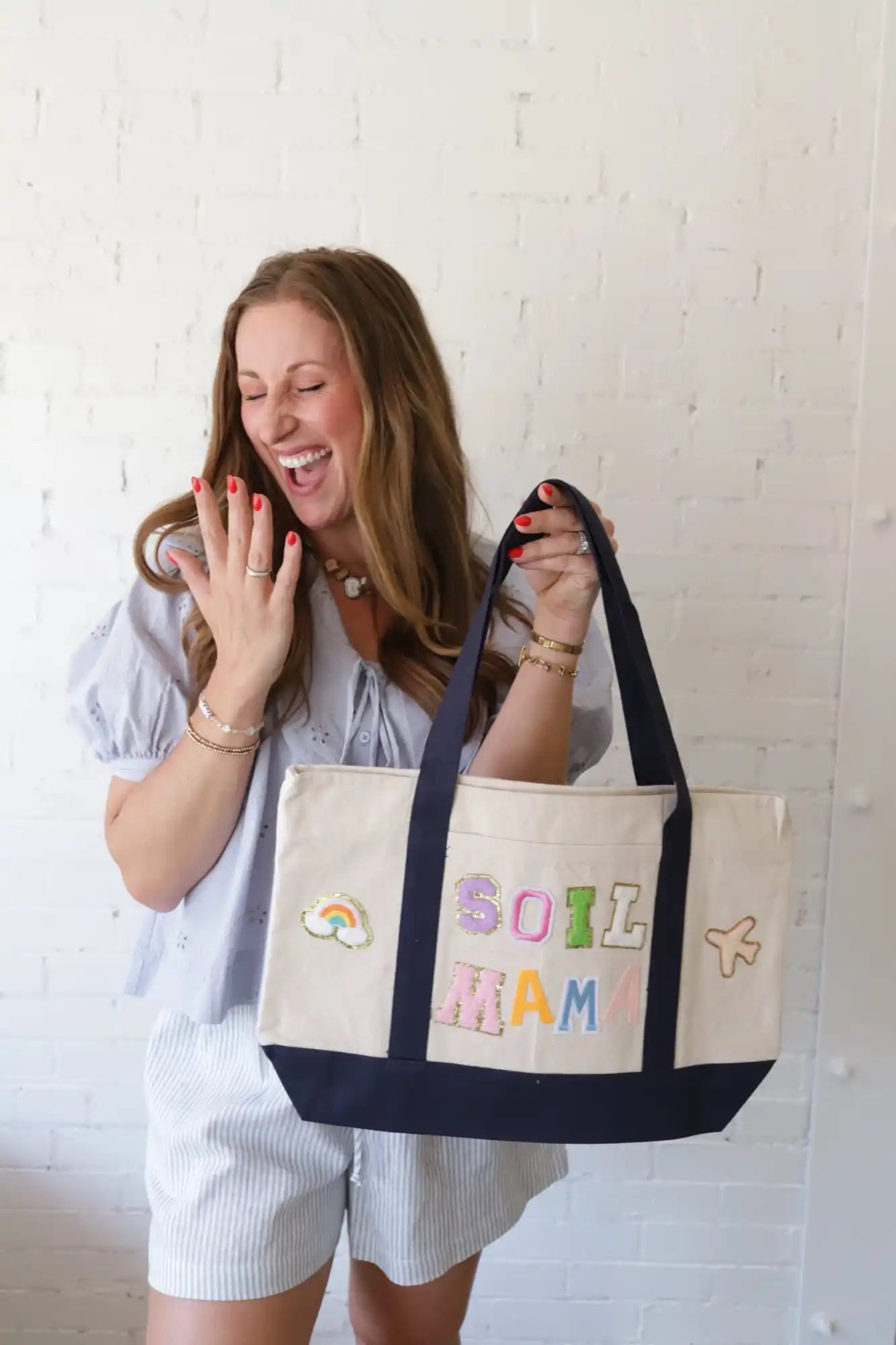 Canvas tote bag with dark blue straps and base.