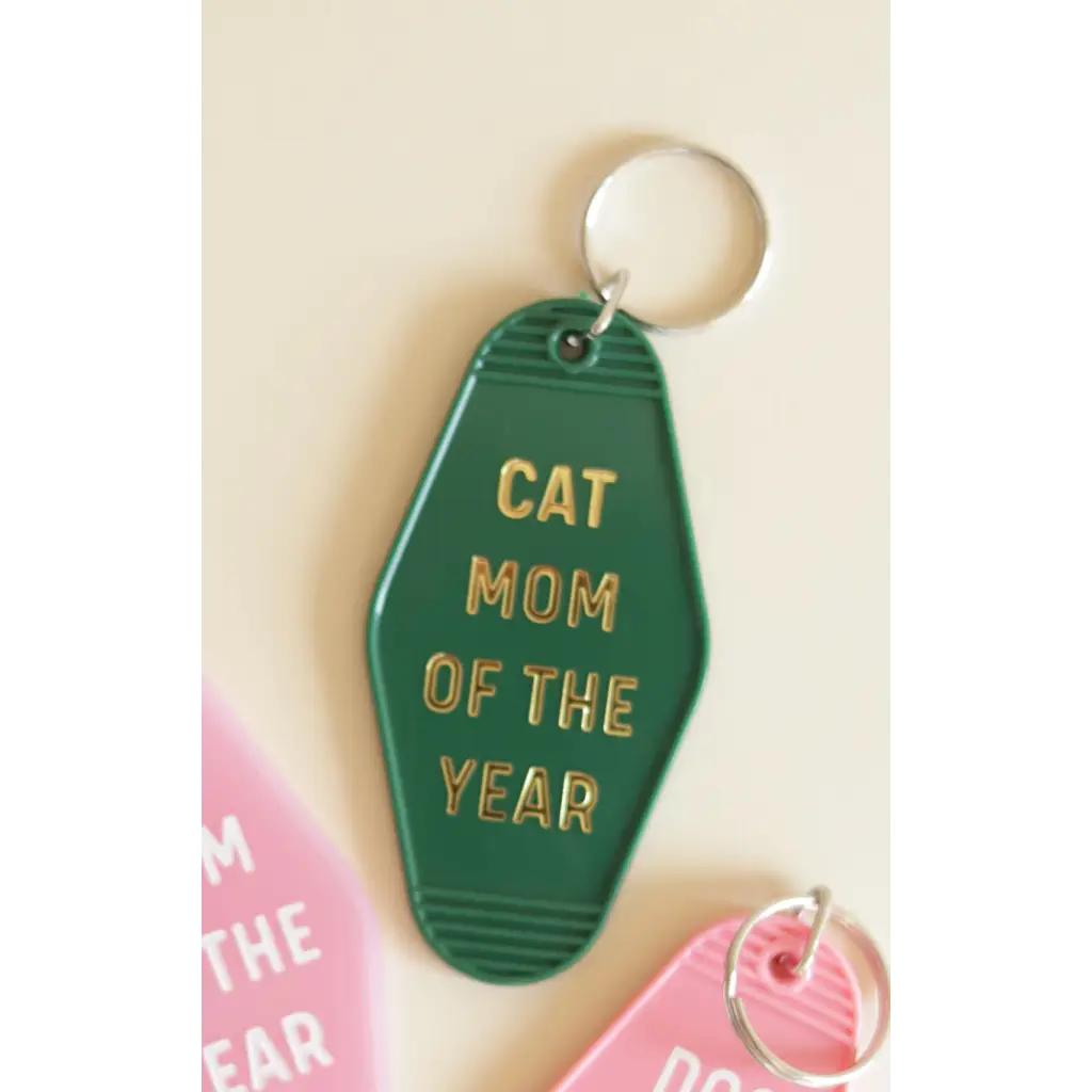 Bright green Cat Mom motel keychain with gold text, perfect for proud cat moms