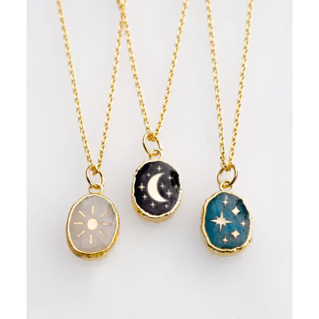 Three gold plated celestial pendants with polished prints on gemstones
