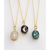 Three gold plated celestial pendants with polished prints on gemstones
