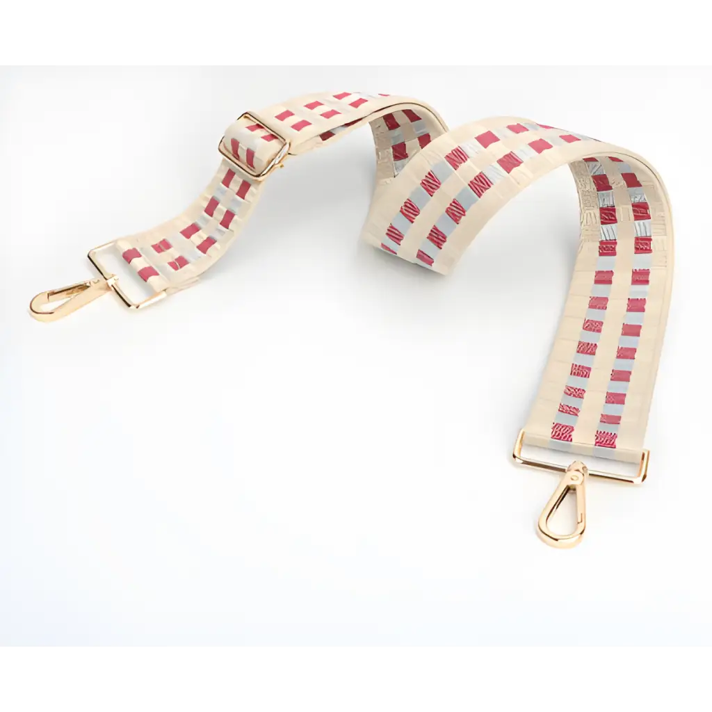 Cream-colored adjustable purse strap with pink checkered pattern and metal clasps