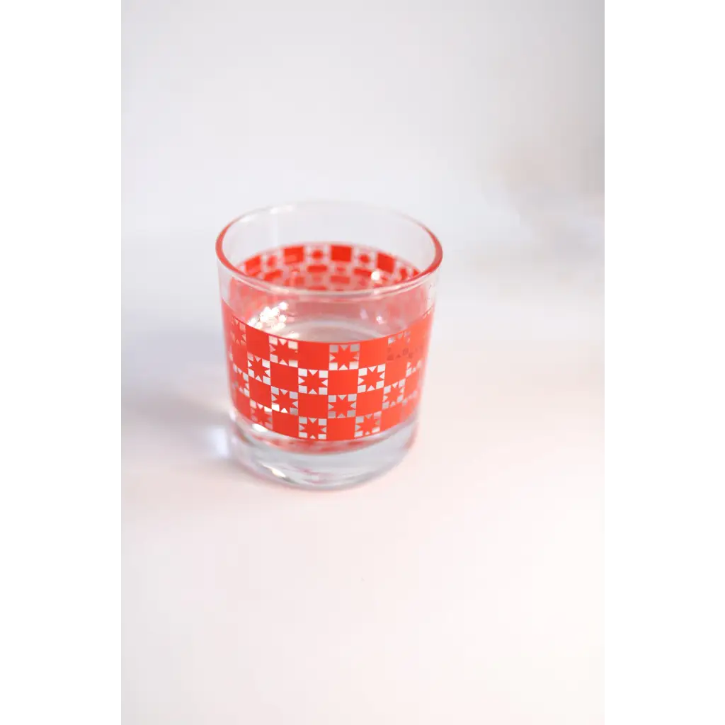 Clear glass cocktail glass featuring red geometric pattern, perfect for any drink