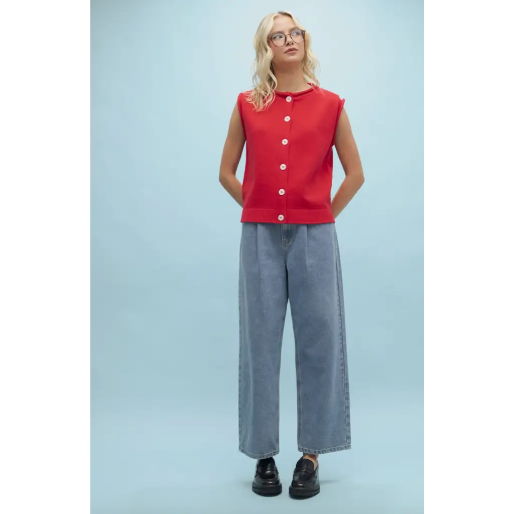Woman in red top and wide-leg jeans wearing Cherry Red Sweater Button-Up Vest for stylish womens clothes