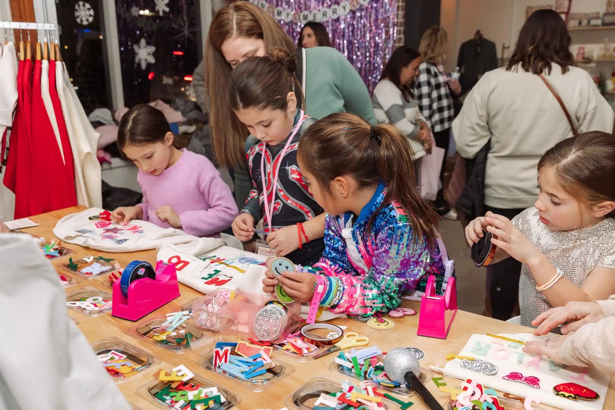 Children gathered around a table working on holiday crafts and decorations.